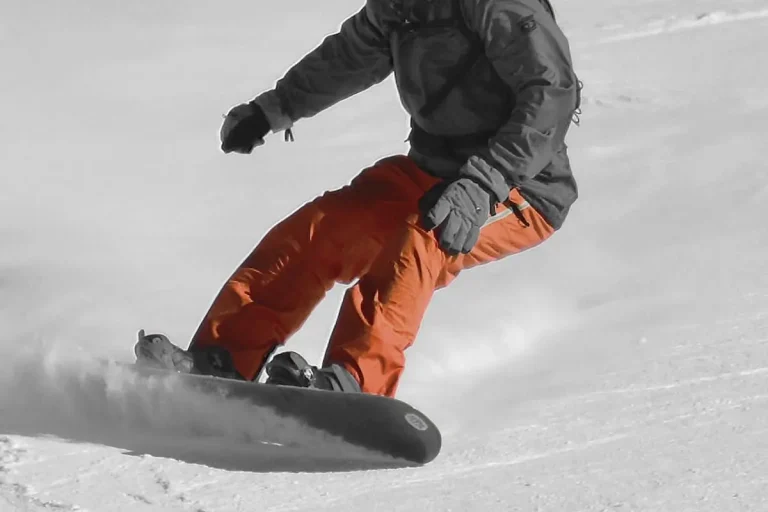 Snowboarder from chest down turning left