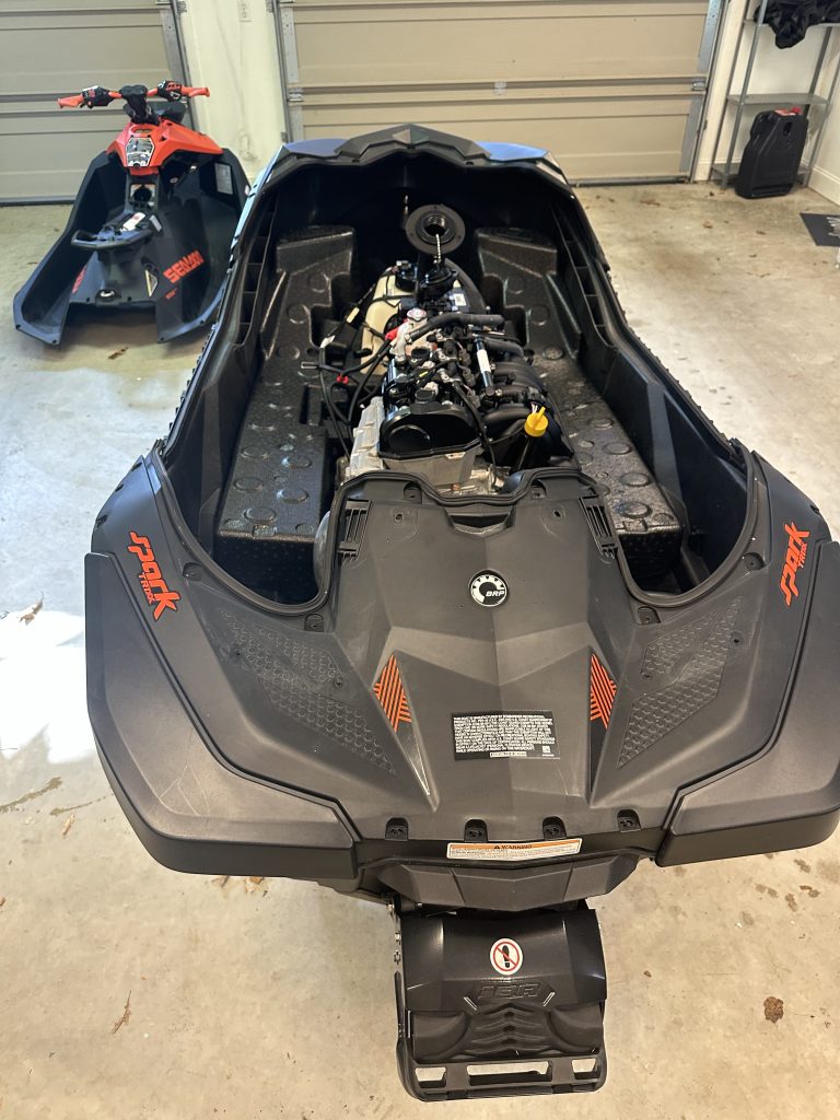 Sea Doo Spark Trixx Red color in my garage with top deck removed and lying on garage floor