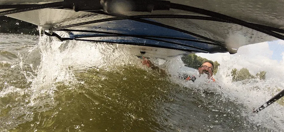 Paddle board photo of person falling off with board in the air, taken from camera on the board